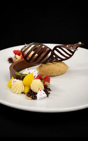 Sweetness is in our DNA 🧬

A silky quenelle of hazelnut mousseline paired with flexible chocolate ganache beneath a delicate chocolate DNA twist, finished with bright passionfruit and delicate raspberry crunch meringue.