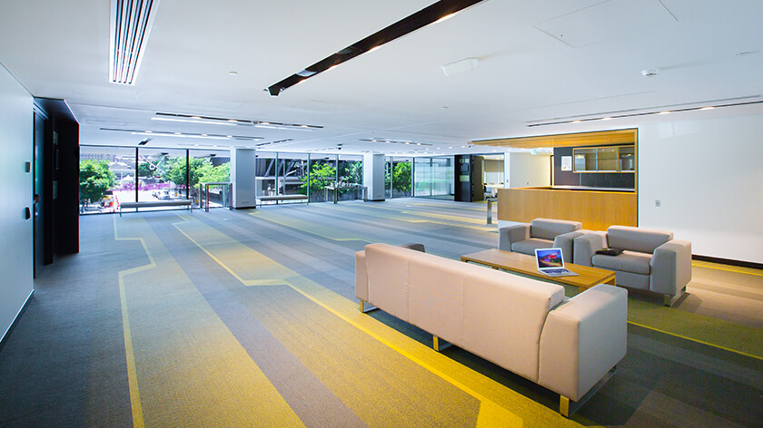 The Arbour Lounge features modern furniture and a visually striking carpet pattern.