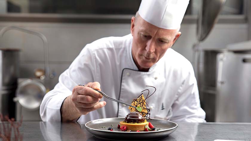 Chef David Pugh putting the finishing touches on a dessert