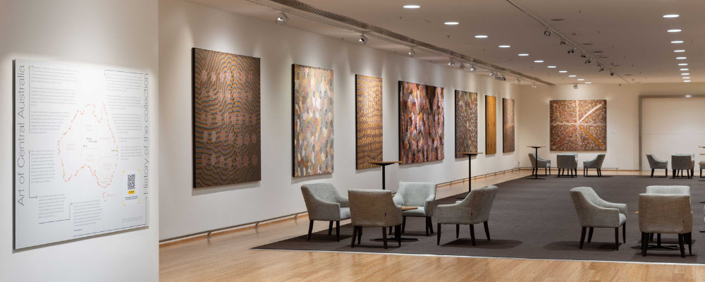 Image of the BCEC Plaza Gallery with artworks from the Papunya Tula collection on display.