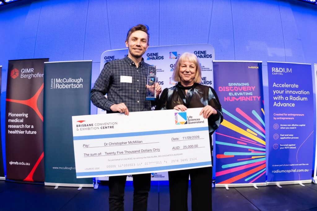 Image of Dr Chris McMillan being presented with the bursary award and check by BCEC's Alison Gardiner at the 2026 Gene Awards.