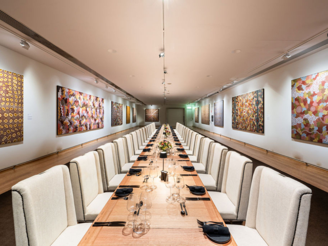 The Plaza Gallery banquet 2 is set with a long table adorned with artworks.